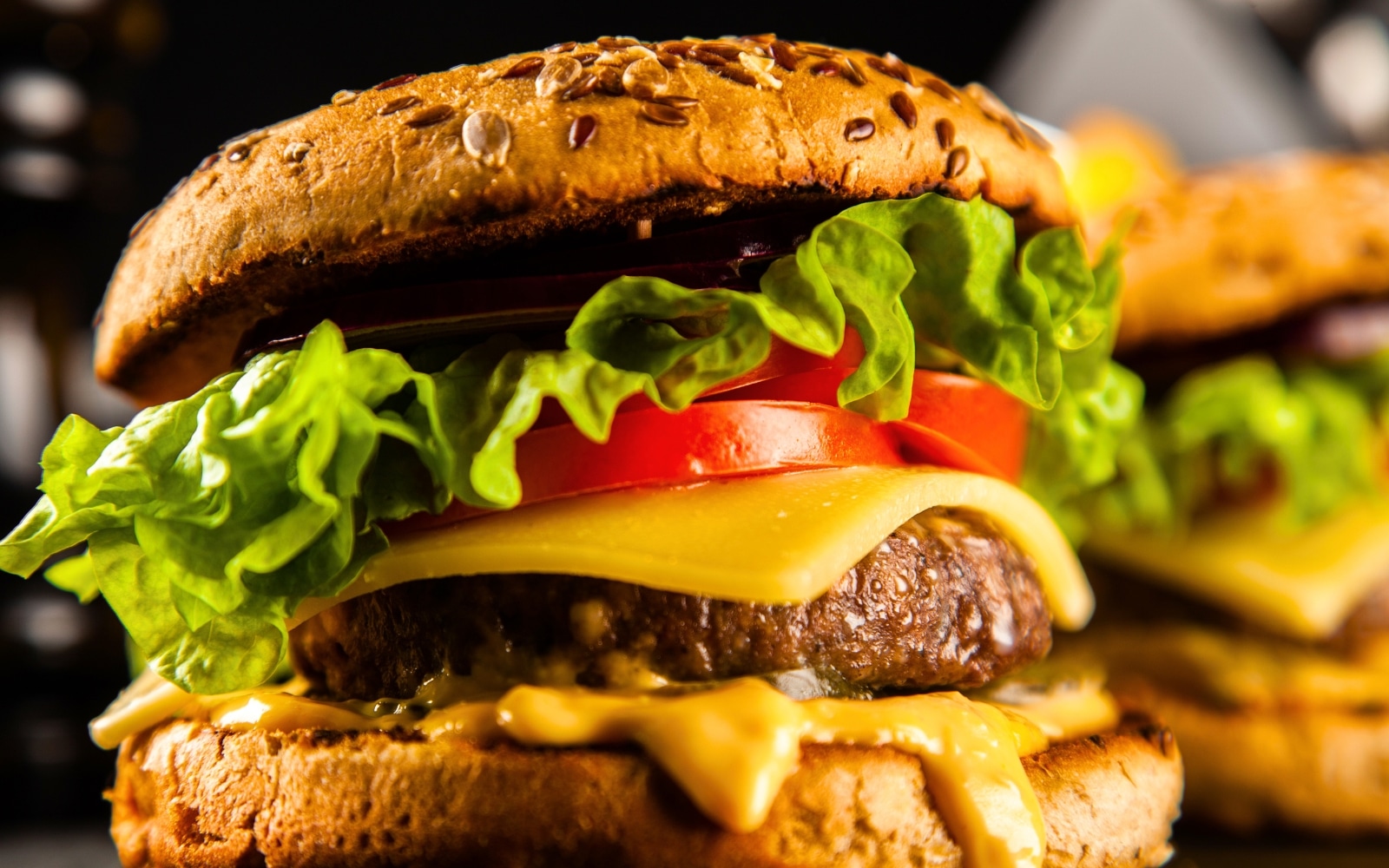 A juicy cheeseburger with melted cheese, fresh lettuce, and tomato on a seeded bun, representing the best burgers in Brandon FL