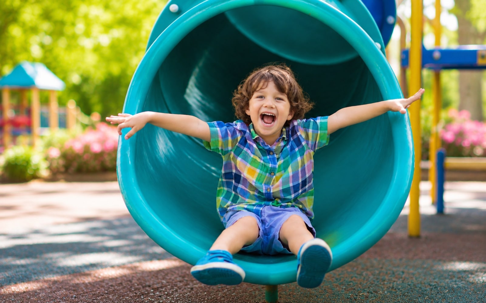 Kid sliding down a playground slide at a local park, things to do with kids in Brandon FL this summer