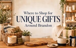 Unique gifts in Brandon FL displayed on a wooden table with candles, jewelry, and wrapped presents